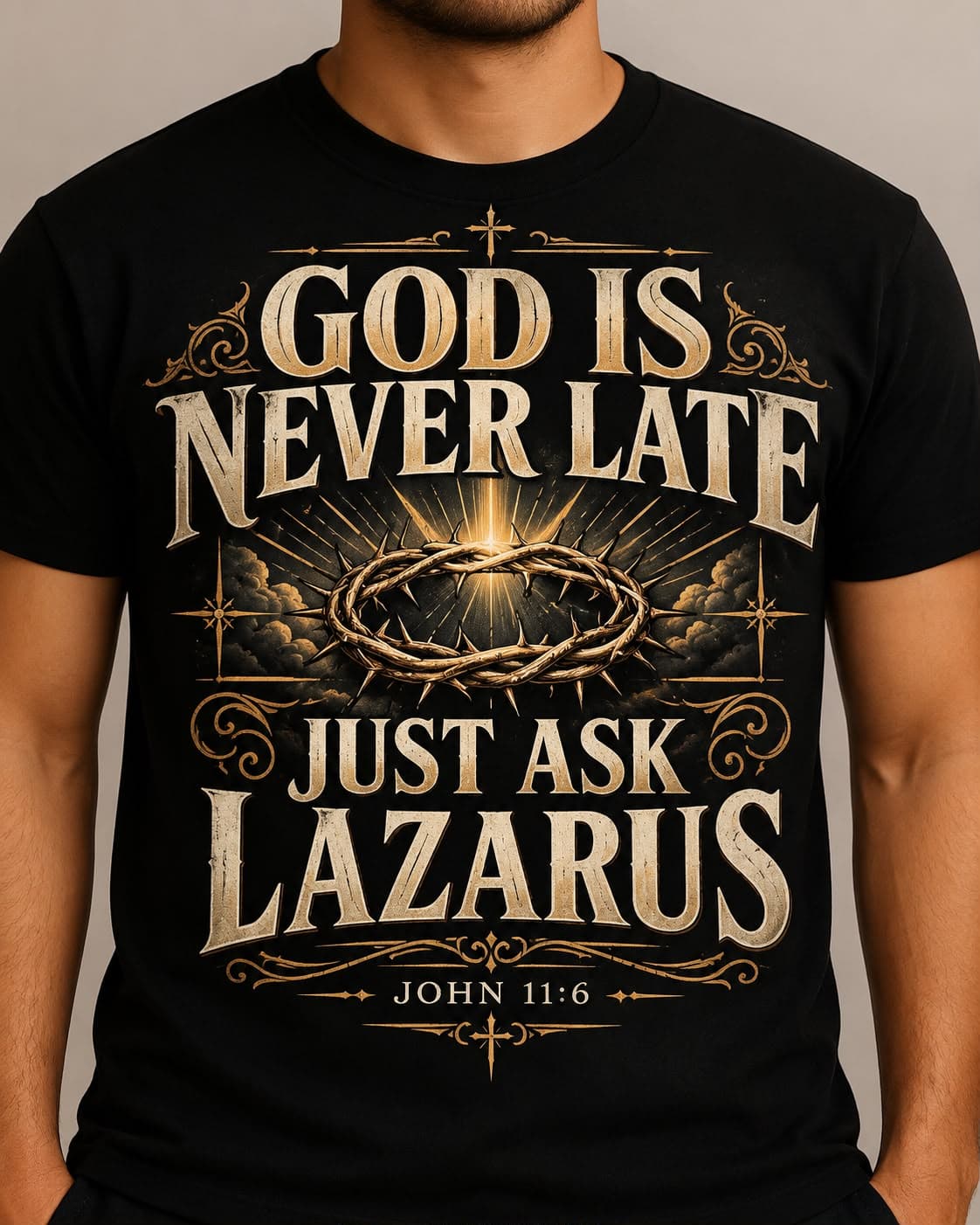 Front of a black tee printed God is never late, just ask Lazarus, with a crown of thorns and John 11:6.